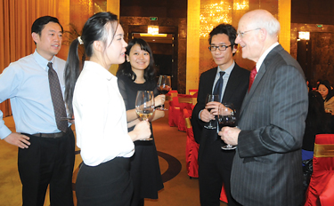 GBA Dean David Gautschi, right, meets with GBA alumni and friends at a reunion in Beijing on Dec. 2. More than 120 GBA alumni and friends attended a banquet and celebation. Contributed photo