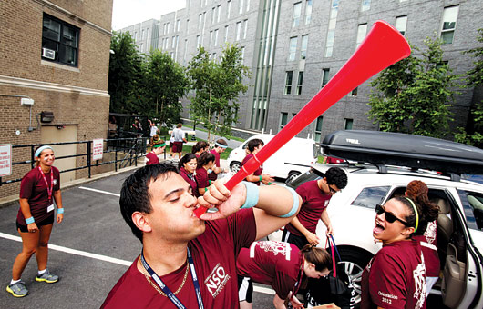 FCRH senior Chris Hernandez, center, was one of the volunteer upperclassmen greeting new Fordham freshmen at Martyrs’ Court—with a vuvuzela. The University welcomed some 1,870 students in the new class. Photo by Bruce Gilbert