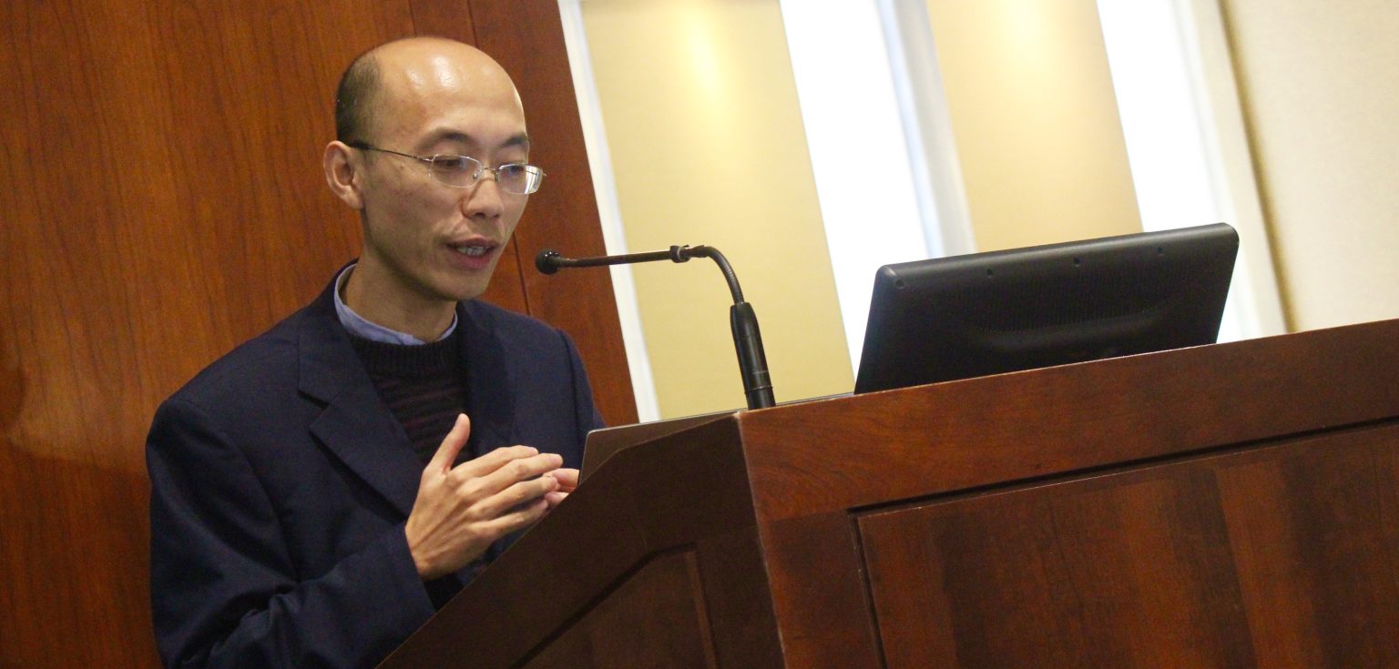 Weiping Zheng, an epistemologist from Xiamen University, speaks about the rules behind making assertions, behind a podium at the front of the room.