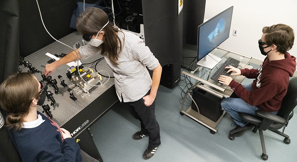 Thrall and students assemble the single molecule florescence microscope. 