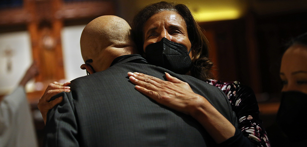 Dean Stovall's widow, Denise Herd, embraces his cousin Jack Smith at the memorial.