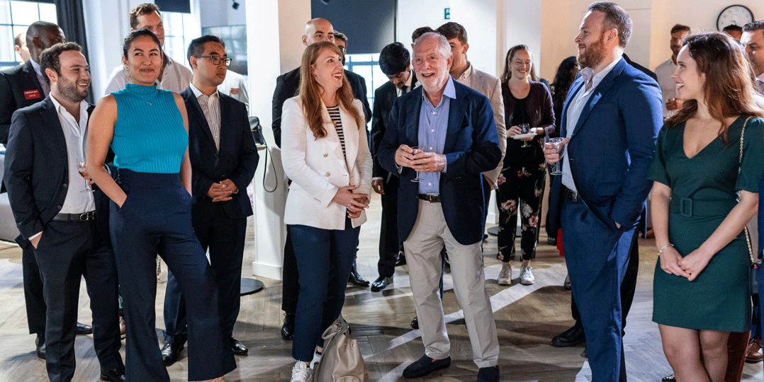 students and advisory board members at a reception