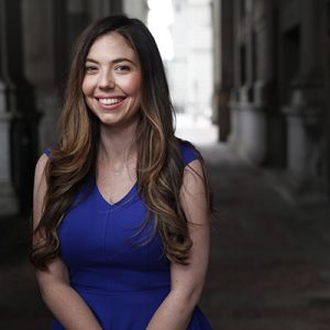 women in blue dress smiling