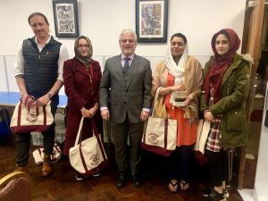 Mishal Ahmed poses for a group photo with four other people.