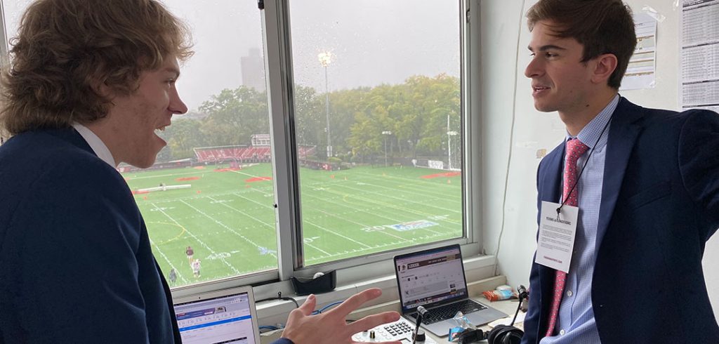 Two students prepare to broadcast a game.