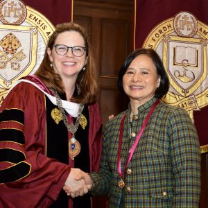 President Tetlow and a faculty member smile at the camera.