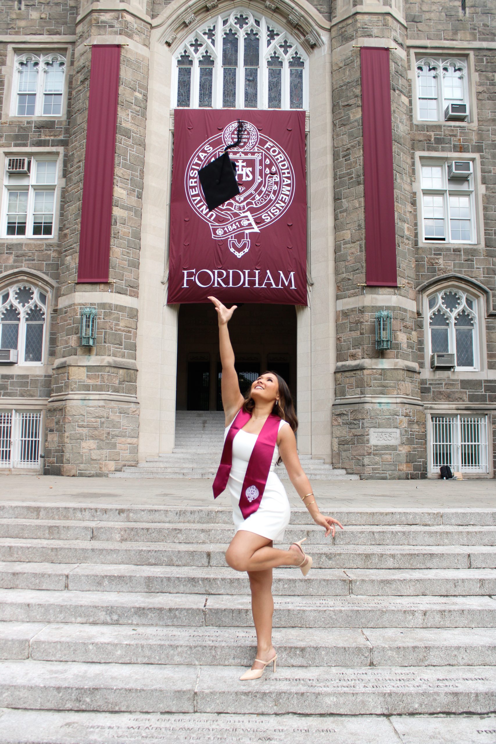 Woman throwing cap in air on Keating steps