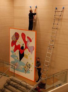 Workers prepare the wall for the painting. Photo by J Lawton