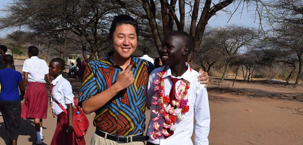 Kang Lee, FCLC '14, in Tanzania with one of his students