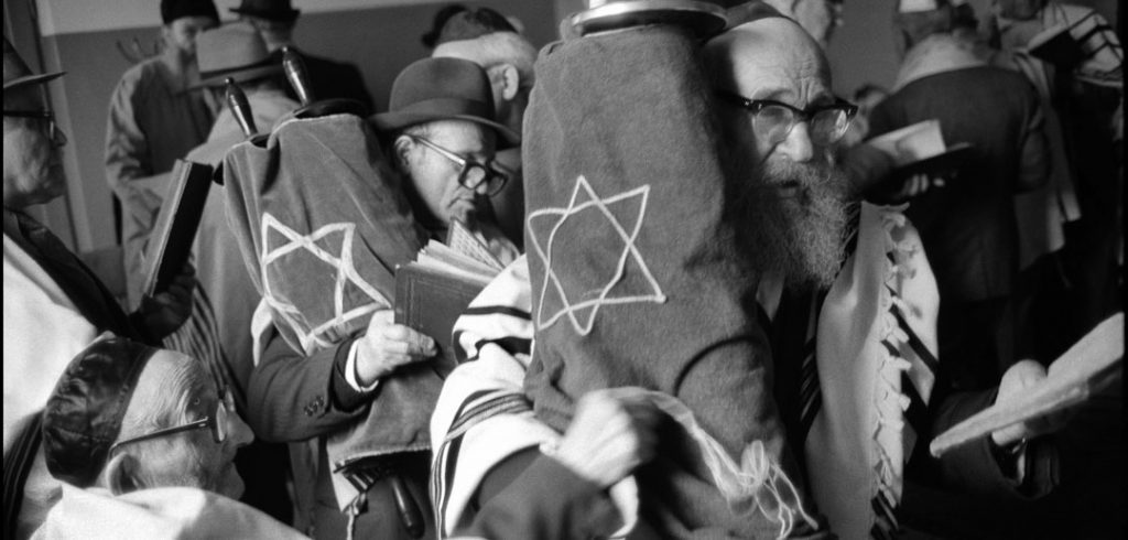 Shabbat service in Warsaw Beit Midrash on Shavuoth. Moshe Shapiro, front, and Natan Cywiak with Torahs. May 21, 1980.