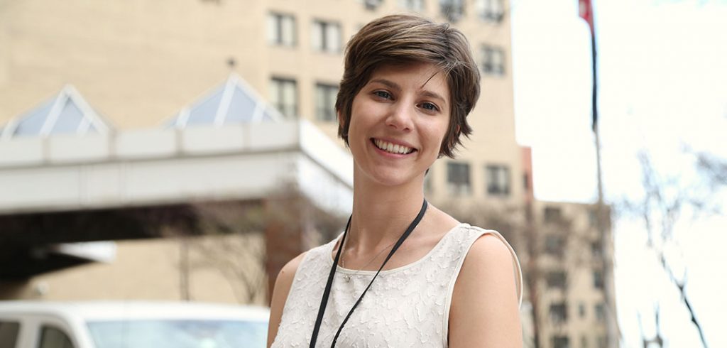 Ashley Selkirk standing in front of the VA hospital in Manhattan