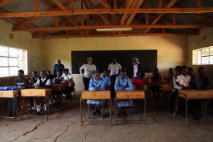 Diane Rodriguez, Ph.D., an associate professor in the Graduate School of Education (GSE), with nuns from the Assumption Sisters of Eldoret and elementary school Kenyan girls.