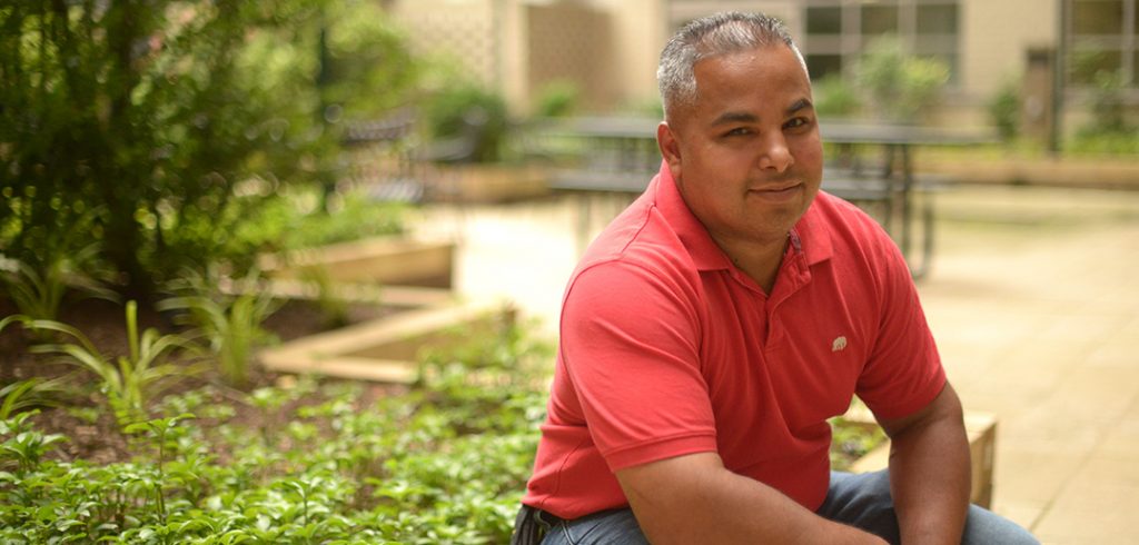 Richard Figueroa sitting on a bench at the Lincoln Center campus