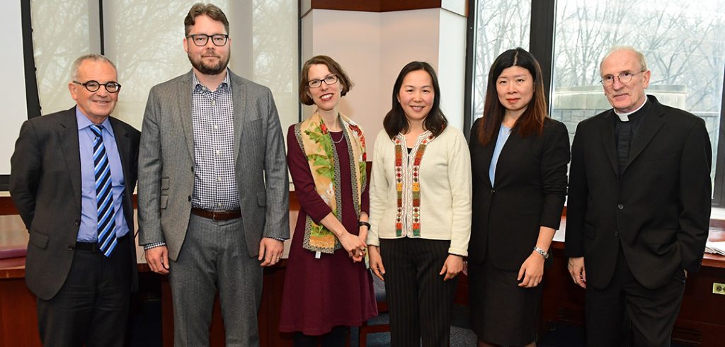 Stephen Freedman, Jason Munshi-South Nina Rowe, Chun Zhang, Yilu Zhou and Joseph M. McShane posse for a photo at the Walsh Library on the Rose Hill campus