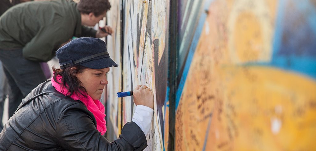 Tourists sign the 'peace wall' in Belfast in 2014.