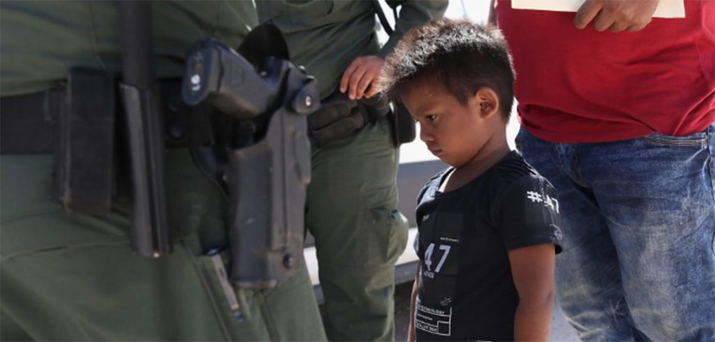 A boy and father from Honduras being taken into custody by United States Border Patrol agents near the Mexico border