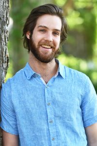 Matthew Combs standing next to a tree