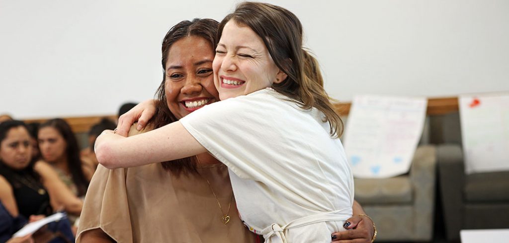 ESl student gets a big hug from her teacher