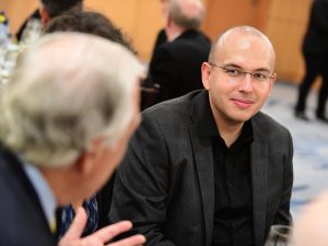 Hans-Joachim "Hajo" Hein, the Kim B. and Stephen E. Bepler Chair in Mathematics, smiles as he listens to an event attendee.