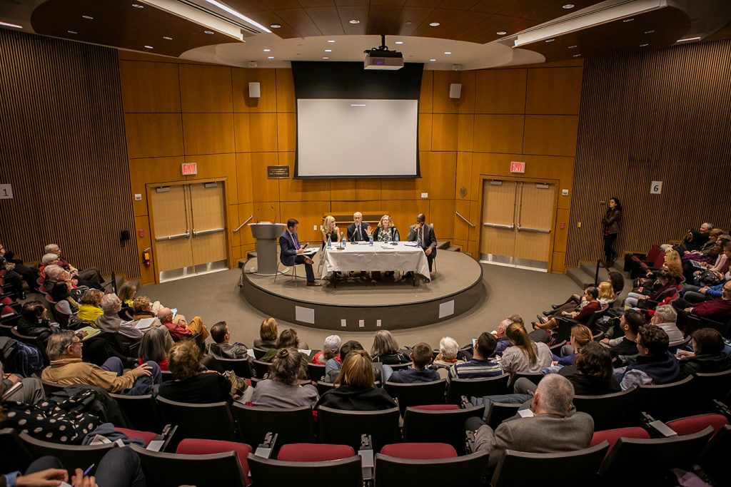 Panelists sit on stage at the McNally Ampitheatre