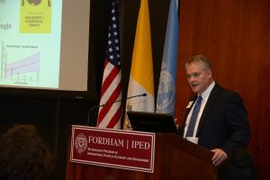 Christopher Barrett speaking at a podium at the Lincoln Center campus