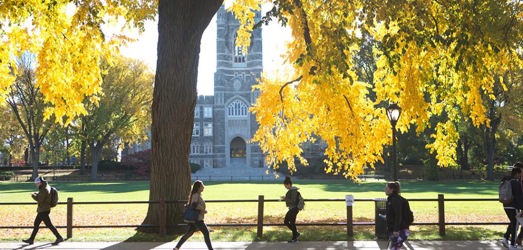 Keating Hall as seen through trees with leaves turning yellow