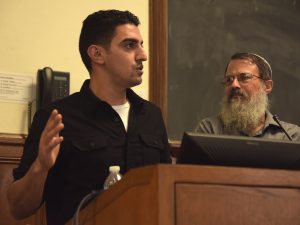 Shadi Abu Awwad speaks from the podium, with Schlesinger beside him 