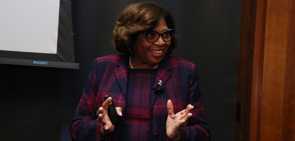 Lorna R. Lewis at a podium in the 12th floor lounge