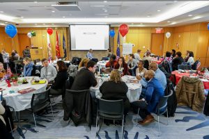 People seated at tables in Butler Commons in Faber Hall.