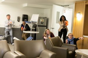 Attendees of Veteran Cultural Competence Training Program pretend to storm a room with nerf guns.