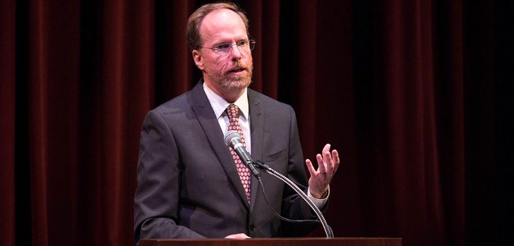 Dennis C. Jacobs speaks at a podium