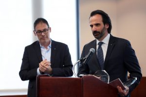 George Demacopoulos and Aristotle Papanikolaou stand at a podium together