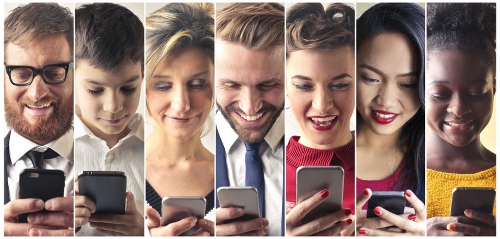 A collage of seven people looking at the their smartphones