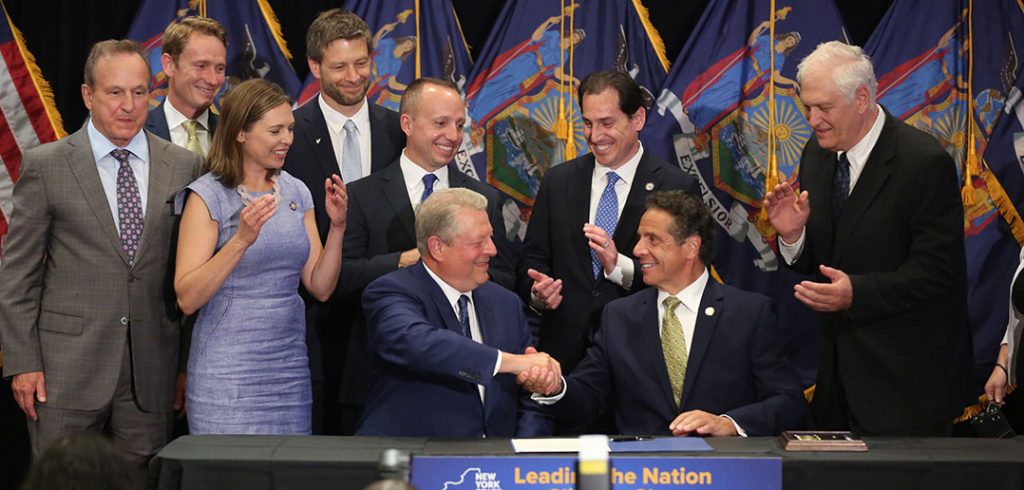 Al Gore shakes Andrew Cuomo's hand during a signing ceremony at Fordham Law School