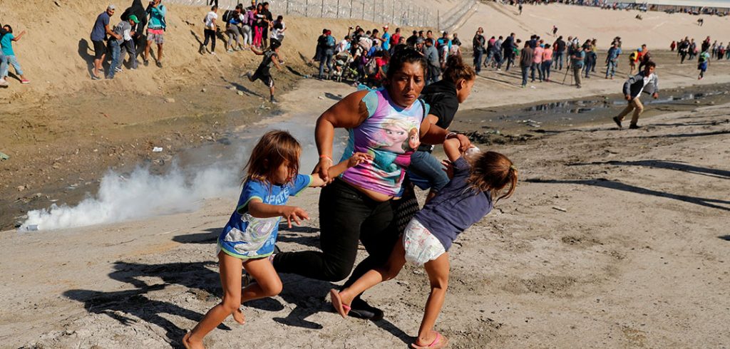 aria Meza (C), a 40-year-old migrant woman from Honduras, part of a caravan of thousands from Central America trying to reach the United States, runs away from tear gas with her five-year-old twin daughters Saira Mejia Meza (L) and Cheili Mejia Meza (R) in front of the border wall between the U.S. and Mexico, in Tijuana, Mexico, November 25, 2018.