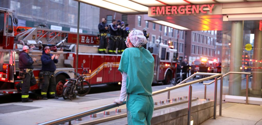 A nurse looks at firefighters