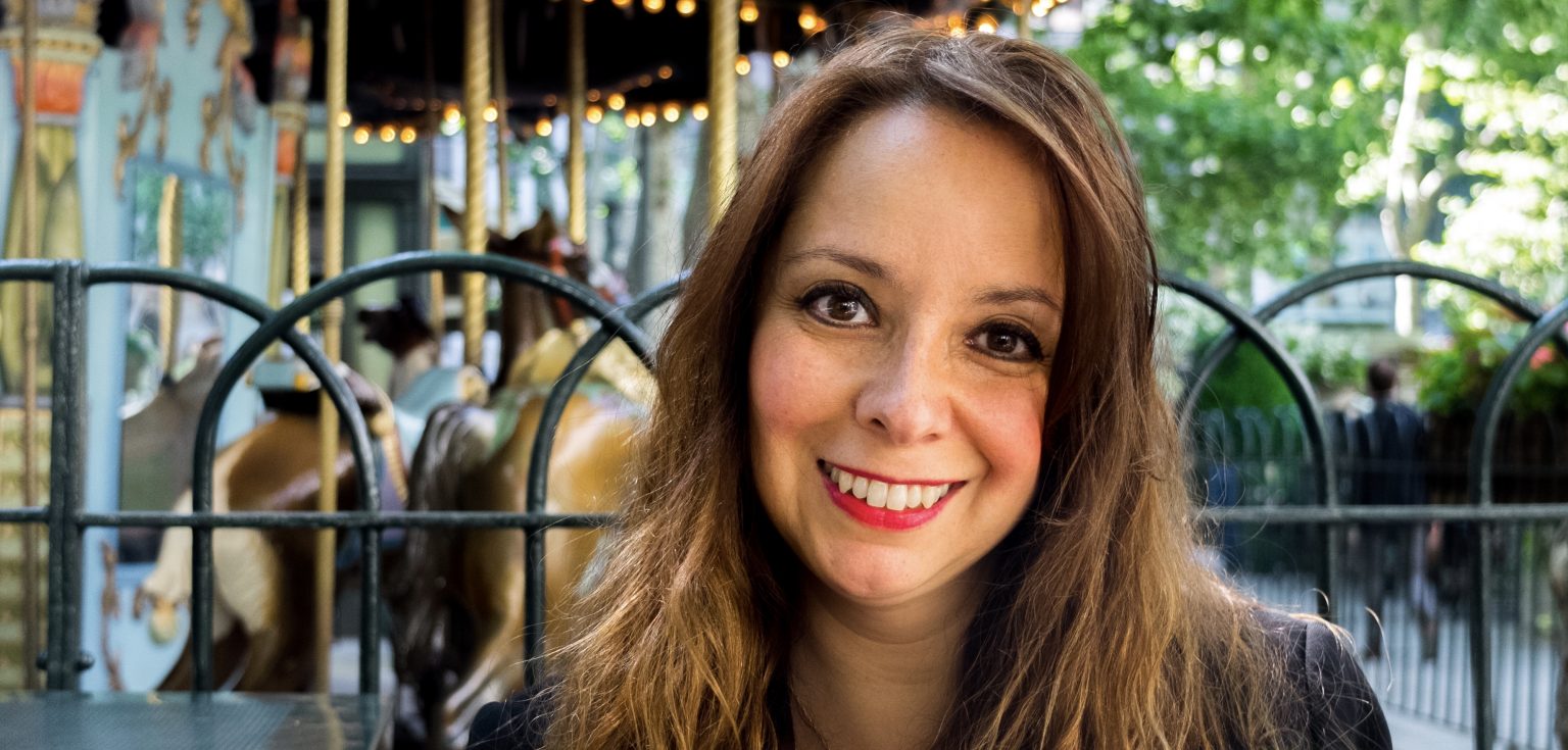 A close-up of a woman smiling at the camera