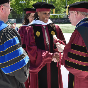 Williams-Isom receives an honorary doctorate from Father McShane at the GSS commencement ceremony in 2018. (Photo by Dana Maxson)