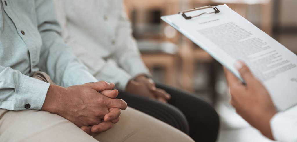 A man answers questions from a doctor