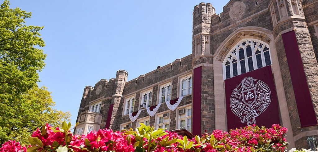 Keating with flowers and Commencement banners