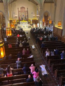 View of the University Church from the choir loft; four priests can be seen lying face down in the center aisle during the Litany of the Saints ceremony