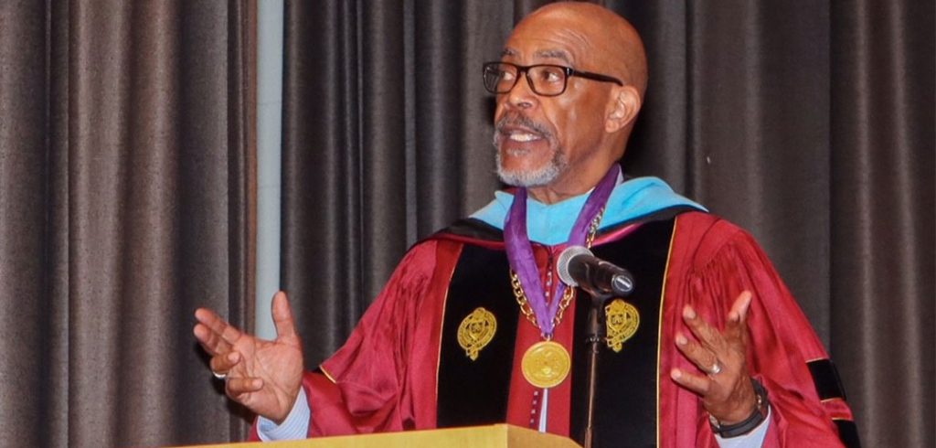 Lester Young, Ed.D., GSE ’78, speaking in Fordham gown.