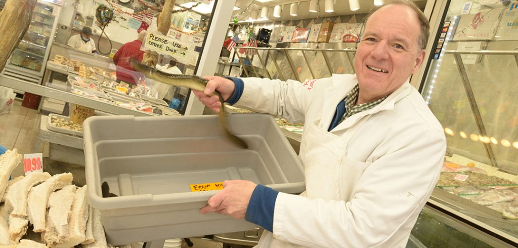 Frank Randazzo handles a live eel, one of the seven fishes to be served on Christmas Eve. 