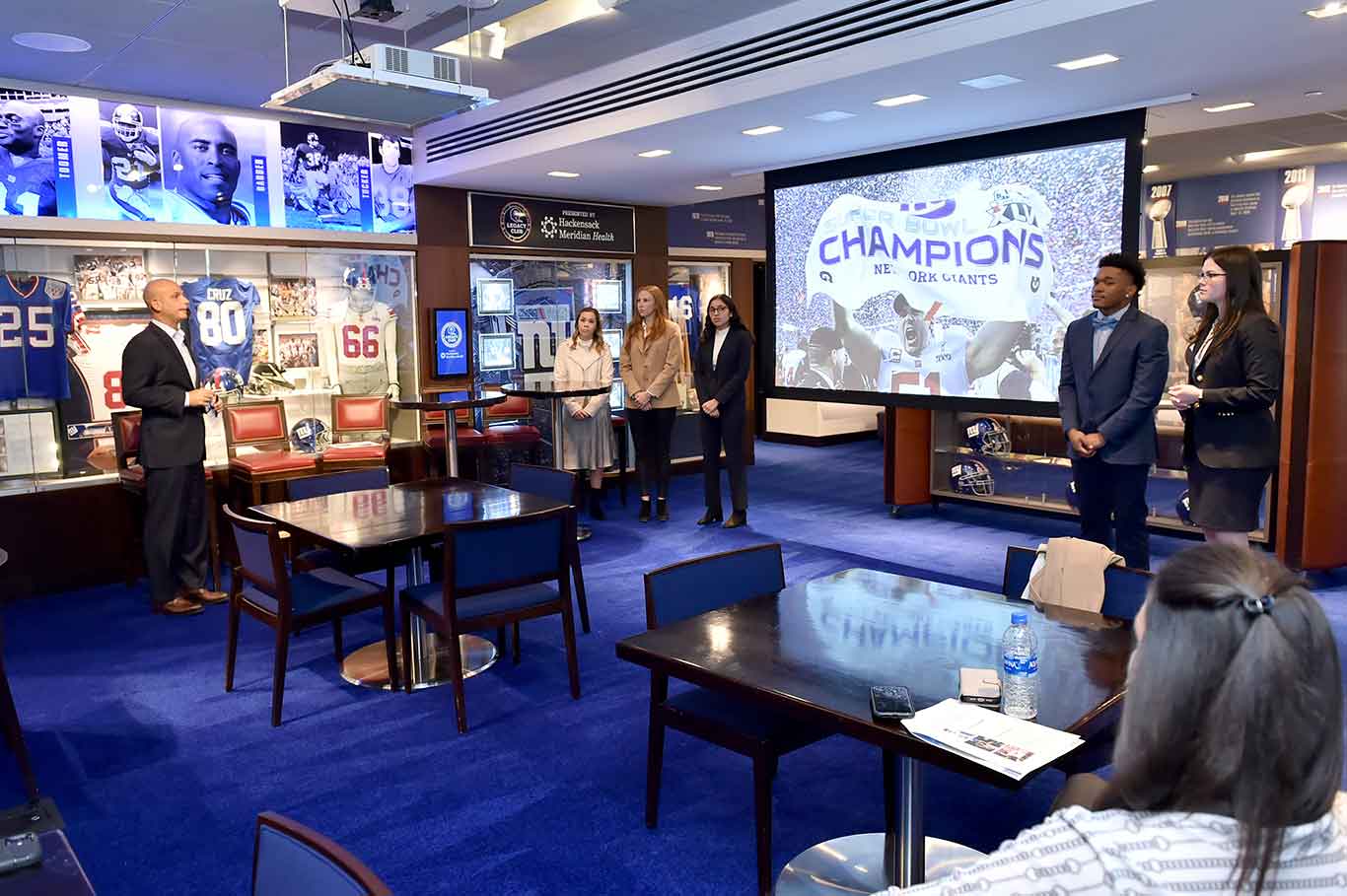 students standing around a video screen