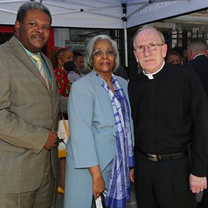 Calvin Butts IV with his mother, Mrs. Patricia Butts, and Father McShane