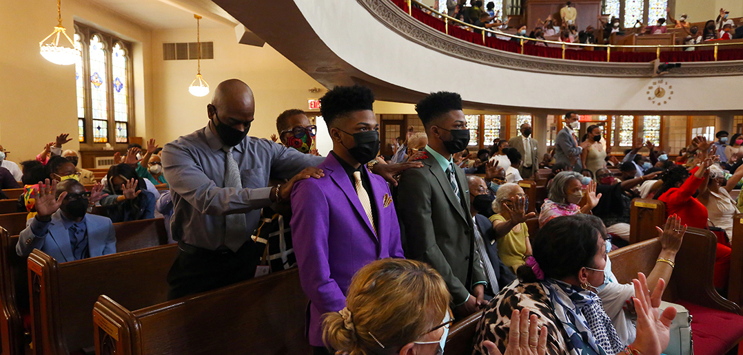 Members of the congregation bless the young scholars