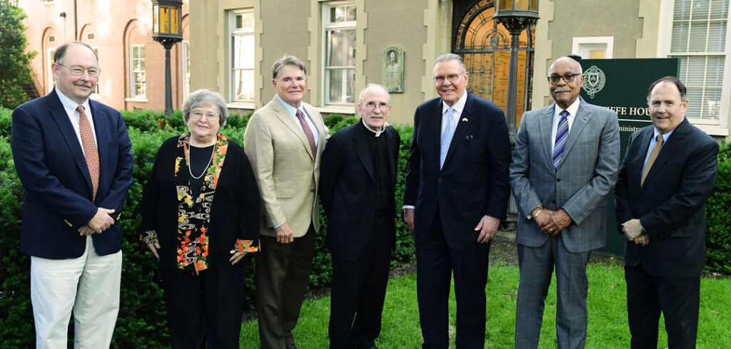 Seven people pose for a photo