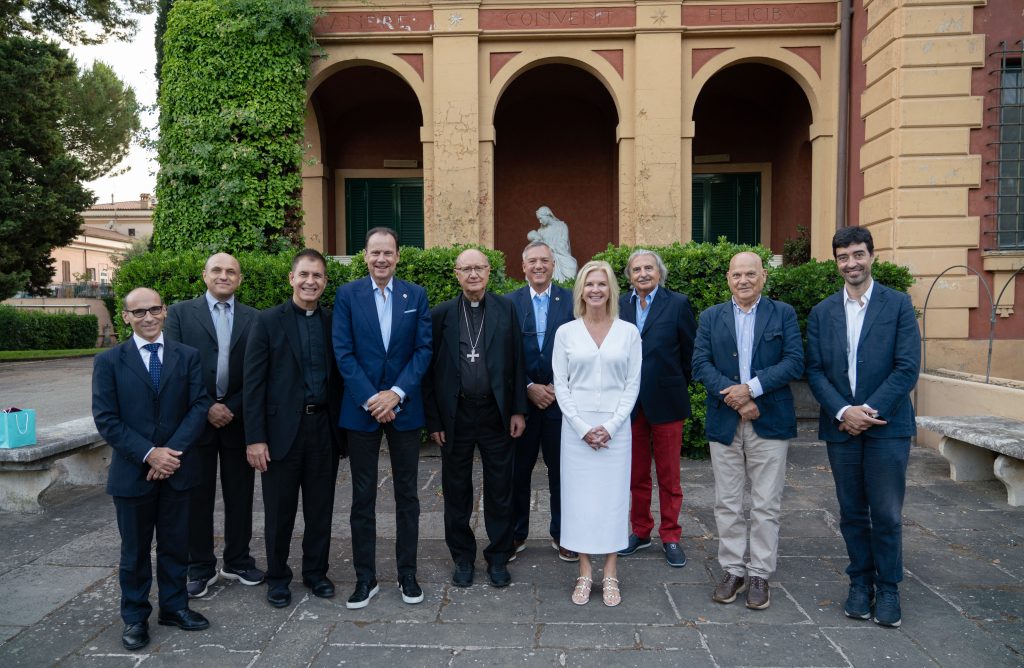 Ten people stand in front of a religious building.