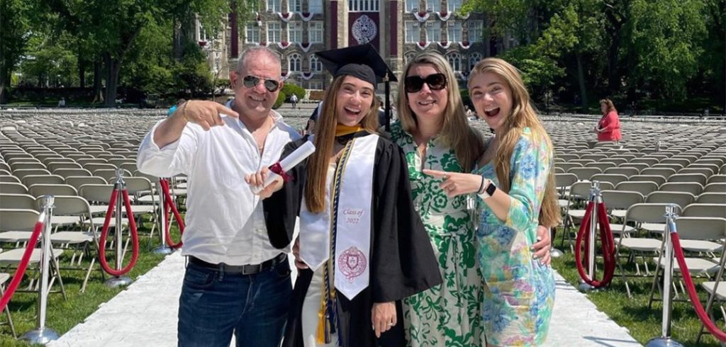 Tiffany Ferreira poses with her father, mother, and sister on Edwards Parade at Fordham's Rose Hill campus