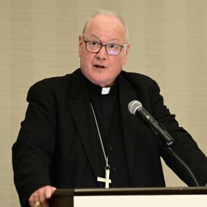 A man speaks at a podium.